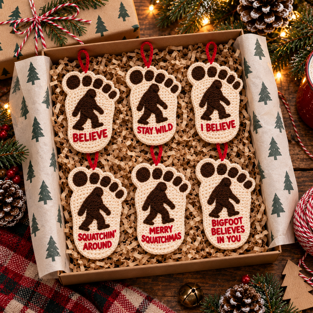 Six cream and brown Bigfoot footprint ornaments arranged in a holiday gift box